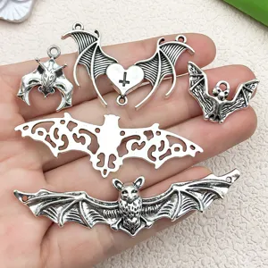 Vintage antique silver bat wing cross pendants for DIY Halloween jewelry making and crafts.