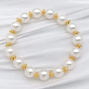 Pearl and gold spacer beaded bracelet detail shot, elegant jewelry accessory design.