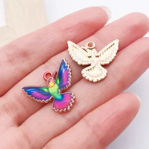 Close-up of alloy enamel flying bird jewelry charms, perfect for DIY necklaces and crafts.