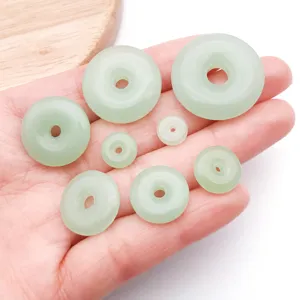 Detail view of light green imitation jade peace buckle beads for DIY jewelry making accessories.