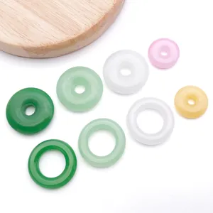 Colorful glass jade donut beads for DIY bracelet jewelry making, delicate smooth detail closeup.