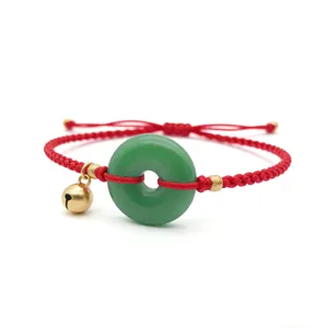 Chinese style green jade donut ping an kou red cord braided bracelet with cute gold bell.