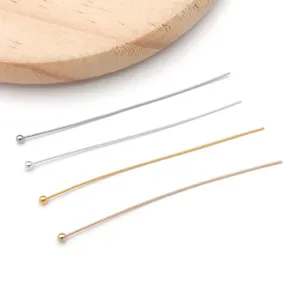 Close up detail of assorted metal ball head pins for handmade DIY jewelry crafting and beading.