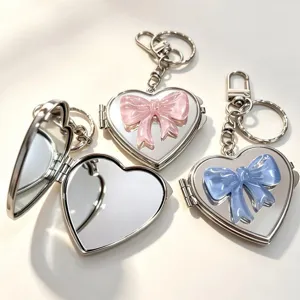 Cute heart mirror keychain with pink and blue bow, stylish silver metal bag pendant.