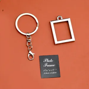 Metal photo frame keychain detail view, blank pendant keyring hardware accessory display.