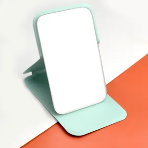 Portable folding desktop makeup mirror featuring mint green leather stand for daily use.