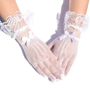 White fishnet lace gloves detail view, featuring delicate bow decoration for bridal wear.