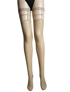 Detail view of women sexy fishnet stockings with elastic garter straps and punk metal rivets.