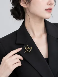 Close-up detail of the elegant hollow peace dove brooch, perfect suit lapel accessory style.