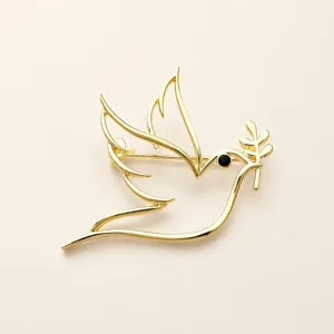 Minimalist gold hollow peace dove brooch detail, elegant lapel pin clothing accessory for daily wear.