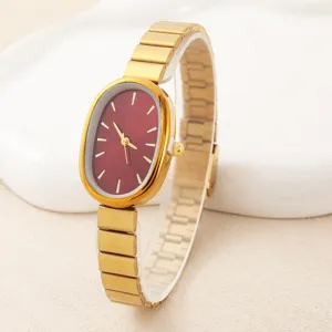 Elegant oval quartz watch for women featuring a stylish red dial and gold steel strap.