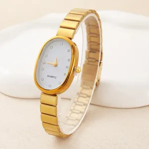 Women's vintage gold oval quartz watch with white crystal dial and metal mesh strap.