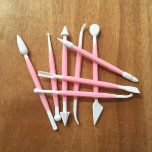 Detail view of fondant and pastry carving tools, showcasing dual-end shaping tips for cakes.