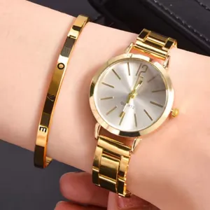 Gold tone quartz watch and matching love engraved metal bangle bracelet set for women detail.