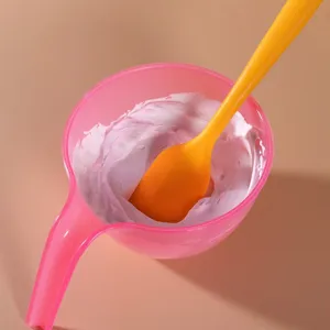 Silicone spatula and pink mixing bowl set for cake baking, cream frosting and color mixing.