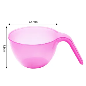 Pink plastic mixing bowl with handle for cake baking, color mixing, and frosting preparation.