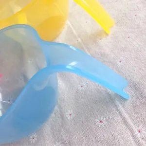 Plastic color mixing bowl detail view, handle design for baking icing and cream preparation.