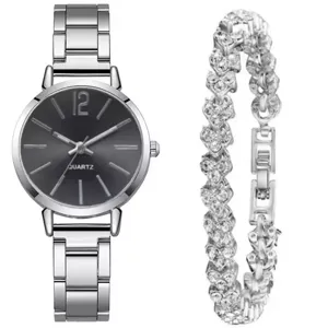 Detailed view of women quartz watch with silver metal strap and matching crystal heart bracelet.