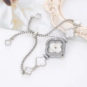 Clover diamond women quartz watch detail shot, elegant silver chain bracelet with white motifs.