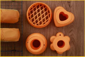 Orange plastic baking mold set, including heart, flower and round shape cutters for pastry and bread.
