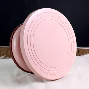 Pink plastic cake turntable baking tool rotating stand for DIY decorating dessert pastry.