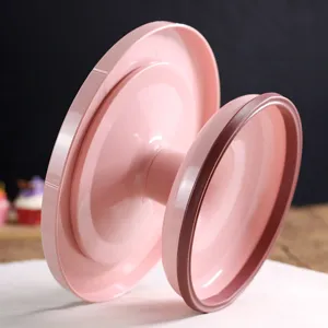 Pink plastic cake turntable stand for DIY baking, rotating frosting display plate securely.