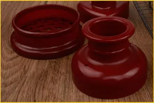 Close-up detail view of red plastic bakery mold set, showcasing tool texture and structure.
