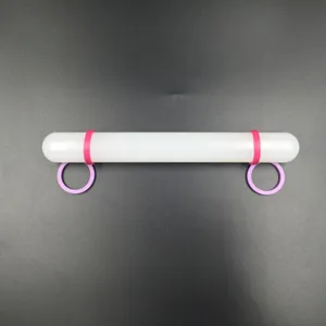 Details of non-stick rolling pin with pink rings for fondant cake baking and pastry making.