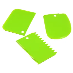 Detail view of three green plastic dough scrapers for baking, cake cutting, and kitchen use.