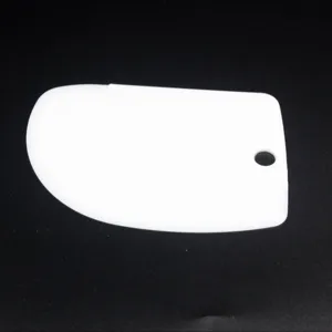 White plastic dough scraper with hanging hole, ideal for baking, cutting dough and cream spatula.