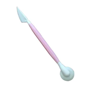 Double-ended fondant sculpting tool and nail art shaping pen with pink handle for DIY crafts.