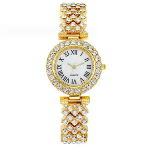 Élégante montre quartz strass dorée pour femme avec cadran blanc et chiffres romains.