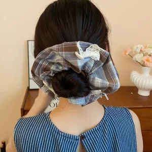 Preppy brown plaid fabric pleated hair scrunchie with lace bow, versatile chic hair accessory.