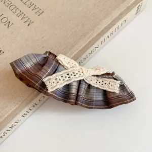 Brown plaid fabric hair clip featuring delicate white lace bow, perfect for daily styling.