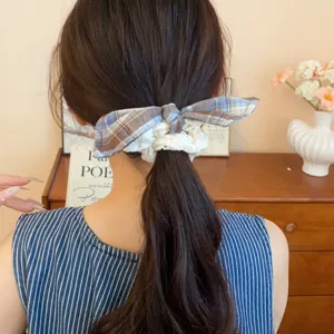 Chic plaid hair scrunchie with white lace bow ribbon, elegant hair accessory for women.