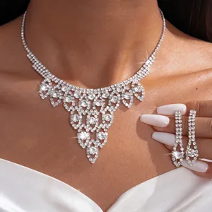 Close-up detail of luxury rhinestone crystal palace necklace and matching drop earrings.