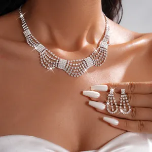 Detailed close-up of sparkling rhinestone multi-strand necklace and drop earrings set.