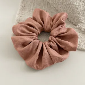 Elegante effen stoffen haarelastiek met zachte metallische glans voor dagelijkse styling.