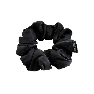 Black satin scrunchie for women, glossy fabric hair tie, elegant ponytail holder hair accessory.