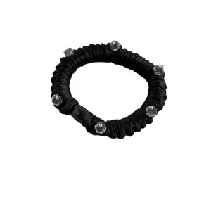 Black pleated satin scrunchie with crystal beads, elegant elastic hair band for daily styling.
