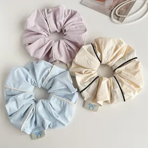 Close up of Korean style piping fabric large hair scrunchie detail, elegant ponytail holder accessory