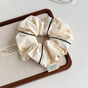 Korean minimalist fabric hair scrunchie with black piping detail for women and girls.