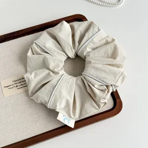Korean minimalist beige fabric hair scrunchie with chic white piping for elegant daily styling.