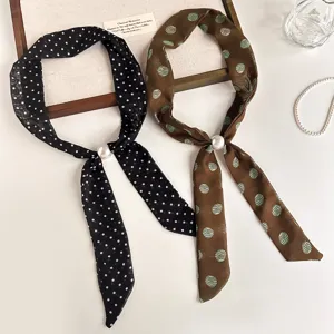 Detalle de diadema de cinta con lunares vintage coreana con elegante decoración de perlas.