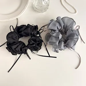 Close-up detail of Korean style sweet lettuce edge bow ribbon pearl hair scrunchie set.