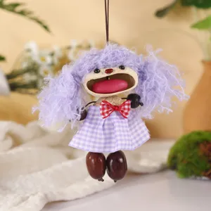 Handcrafted natural nut shell doll pendant with purple curly hair and plaid skirt for decor.