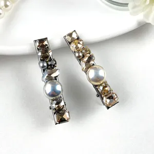 Close-up detail of luxury rhinestone and pearl duckbill hair clip, elegant design for women.