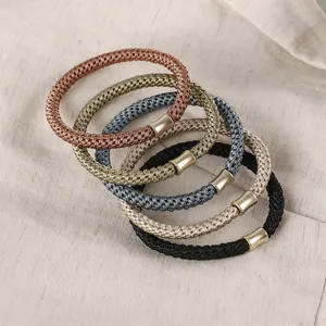 Close-up of colorful braided hair ties with metallic tubes, Morandi tones, durable stretch.