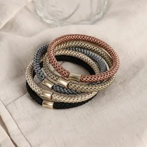 Set of Morandi color braided hair ties with metallic tube accents for daily chic hairstyles.
