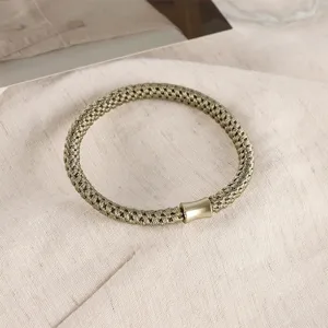 Detailed close-up of a braided Morandi color hair tie with metal tube decor, elastic.